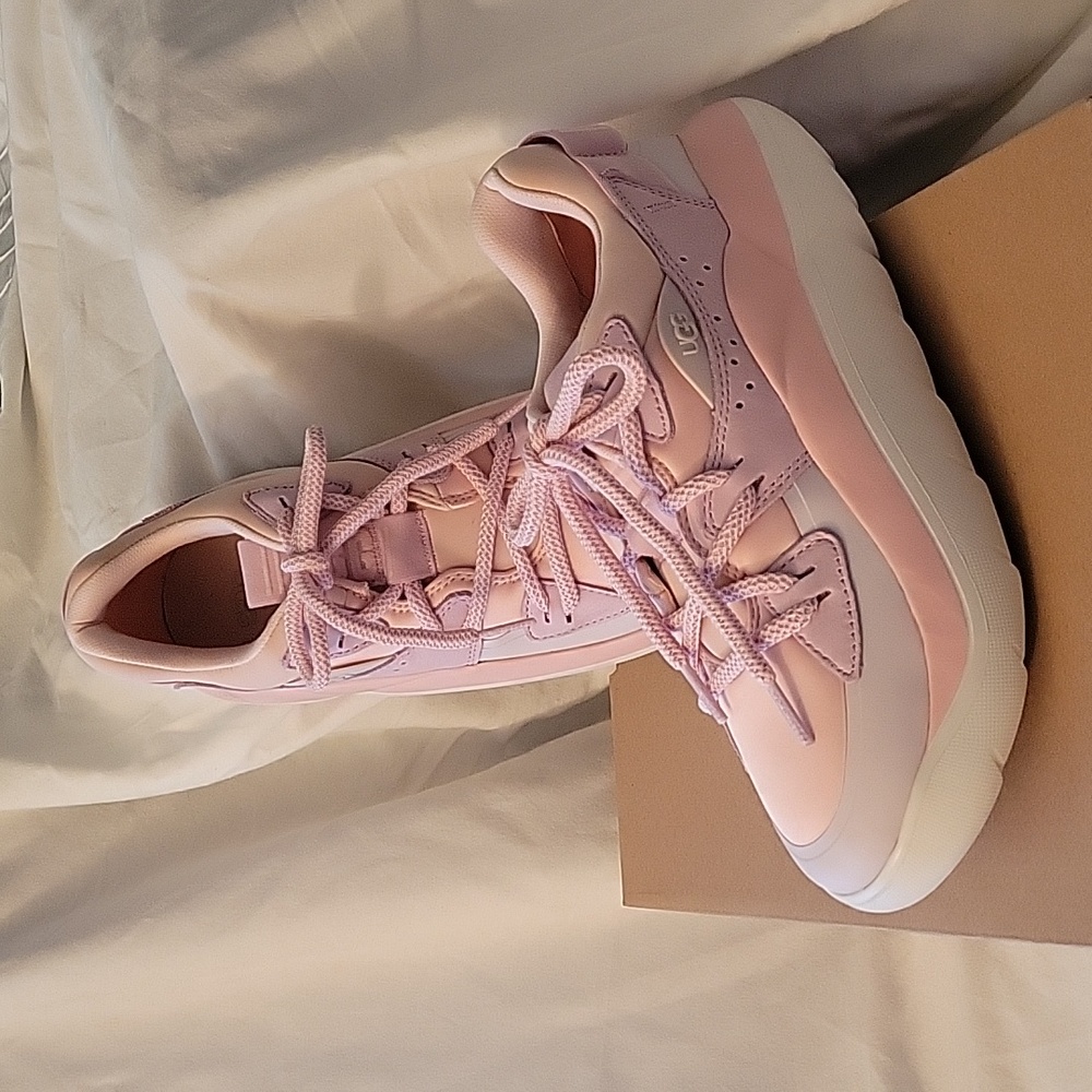 New in the box, Ugg Sneakers, size 9, in shades of pink n white.
